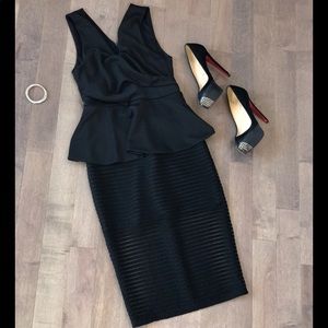 Sleeveless black midi peplum dress